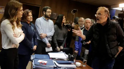 Reuters Protesters from the Communist-affiliated trade union PAME argue with Greek Labour Minister Effie Achtsioglou (L), 9 Jan 18