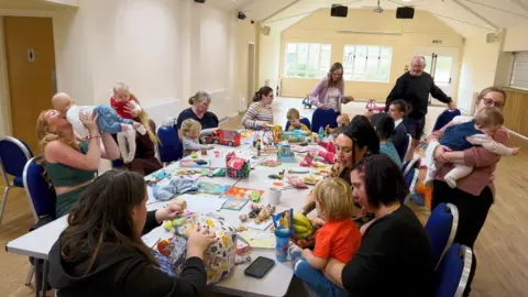 Group of parents and children around a table