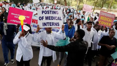 Reuters Doctors and medical practitioners under the Kenya Medical Practitioners Pharmacists and Dentists Union (KMPDU) participate in a demonstration to demand payment of their salary arrears and the immediate hiring of trainee doctors, among other grievances, in Nairobi, Kenya, April 9, 2024