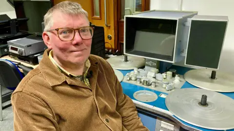 Professor Justin Smith, sat at a vintage editing desk