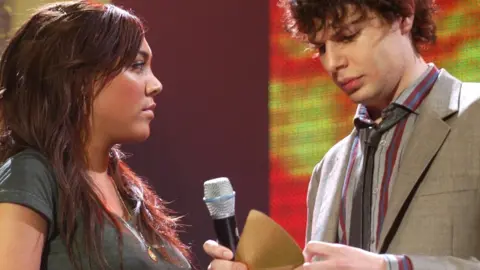 Getty Images Amstell and his Popworld co-presenter Miquita Oliver at the Smash Hits Poll Winners Party in 2004