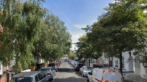 A general view of Stuart Street, which is a tree-lined street with cars parked on either side of the road
