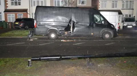 Met Police Damage to a van parked opposite to the Ulez camera pole, in the front of the picture