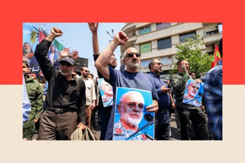 AFP via Getty Images People hold pictures of Major General Gholam Ali Rashid, senior commander of Iran's Islamic Revolutionary Guard Corps (IRGC), as they gather for a protest in central Tehran on 13 June 2025