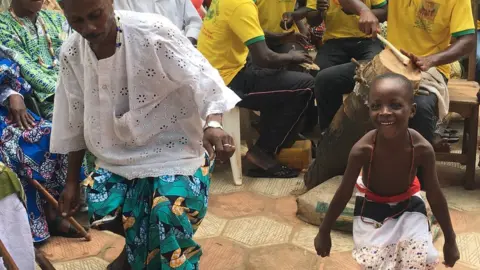 voodoo followers dance during a cleansing ceremony in Ouidah