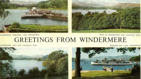 Lake Windermere Cruises Four colourised photographs featuring views of Windermere fringed by trees with mountains in the background. A banner saying "Greetings from Windermere" bisects the image.