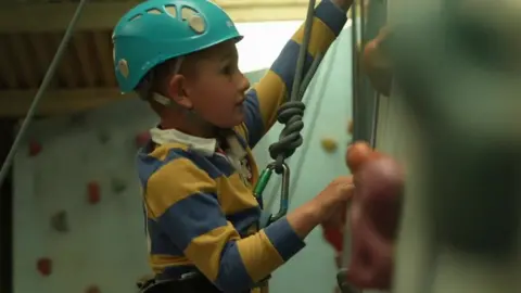 A child does wall climbing