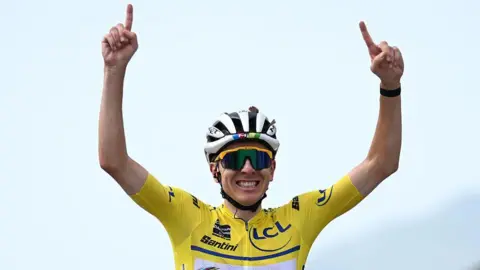 Tadej Pogacar celebrates his stage win on Saturday