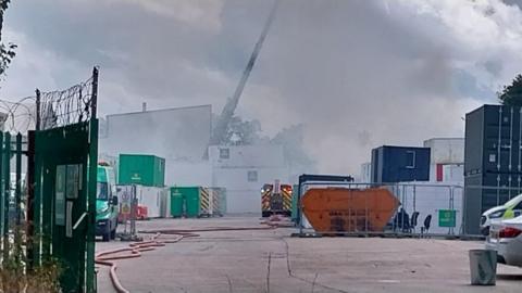 Smoke fills the air at an industrial estate.