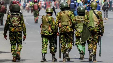 Getty Images Kenyan police patrol during an anti-tax protest in Nairobi