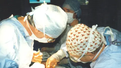 Royal Papworth Hospital Prof John Wallwork (r), photographed in the operating theatre