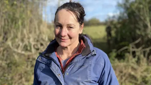 BBC A women with brown hair in a blue jacket