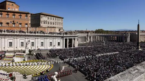 Reuters Members of the clergy walk among the faithful as Pope Leo XIV leads the Easter Mass in St. Peter's Square at the Vatican