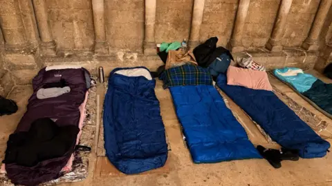 Light Project Peterborough Sleeping mats laid on the concrete floor.