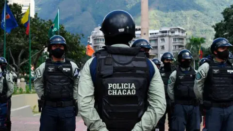 Getty Images Municipal police officers take part in ceremony to launch a security operation in Caracas, 1 December 2020 (Photo by YURI CORTEZ/AFP via Getty Images)