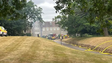 Emergency services pumping water to tackle a fire at an Edwardian building.