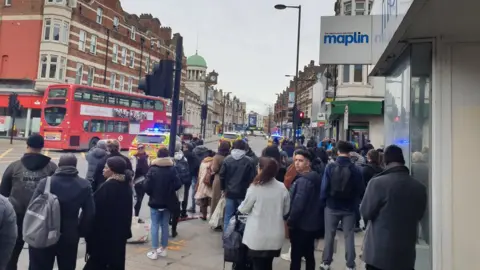 Wellzy Ryder People gather in street