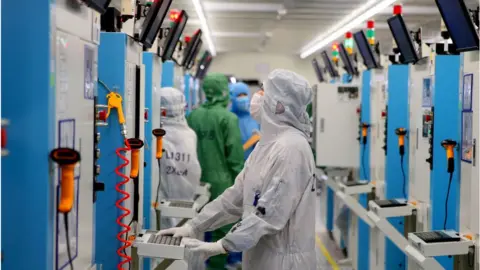 Getty Images Employees work on the production line of silicon wafer at a factory of GalaxyCore Inc. on May 25, 2021 in Jiashan County, Jiaxing City, Zhejiang Province of China.