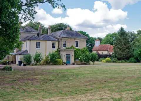 The rectory and church in distance