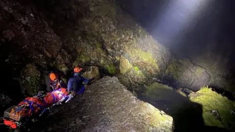 Cockermouth Mountain Rescue Team Rescuers and stretcher in dark
