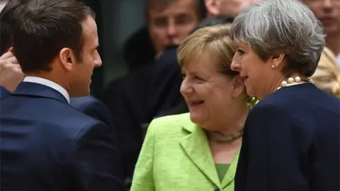 AFP Theresa May with Angela Merkel and Emmanuel Macron at the summit