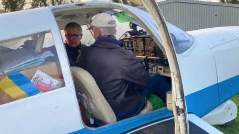 Mr Gruber and Mr Beath in the cockpit preparing to leave