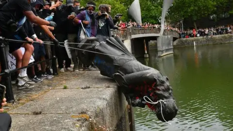 PA Media Statue thrown in the harbour