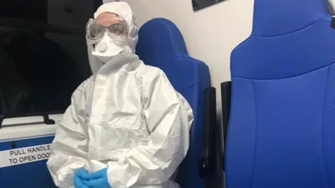 Jozef Wallis people in hazmat suits transport Mr Wallis home