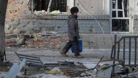 Reuters A man walks down a street in Bakhmut