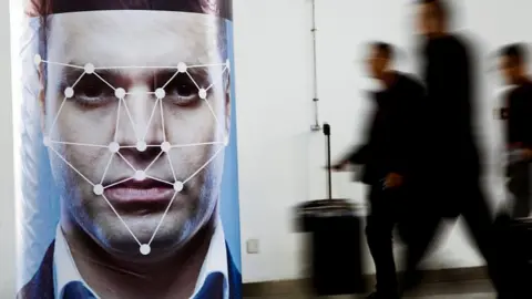 Reuters A poster simulating facial recognition software at the Security China 2018 exhibition in Beijing, October 24, 2018