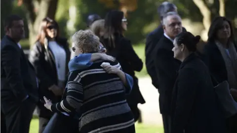 AFP Women embrace as they arrive outside the Rodef Shalom Congregation where the funeral for shooting victims Cecil Rosenthal and David Rosenthal will be held