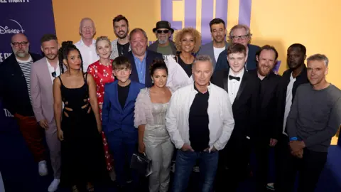 PA Media Actor Robert Carlyle (front) with other cast and crew at the Full Monty series premiere in Sheffield on 5 June