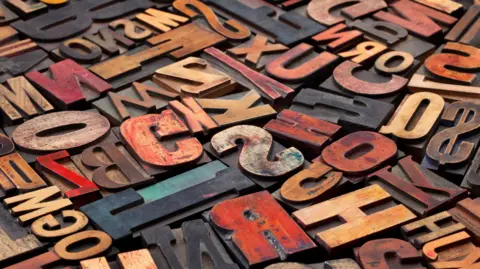 Getty Images Antique wood letterpress printing blocks with colour ink patina, random collection of different size and style.