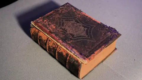 An old Bible. The outer cover looks worn and the pages are a bit brown and discoloured.