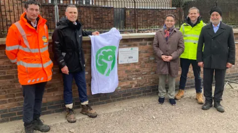 John Tidy from Jackson Civil Engineering, Ian Jones from the Environment Agency, councillor Finlay Gordon Mccusker, Ian Cook from the agency and Kulvinder Rayat from Arup At The Fowlea Brook plaque unveiling