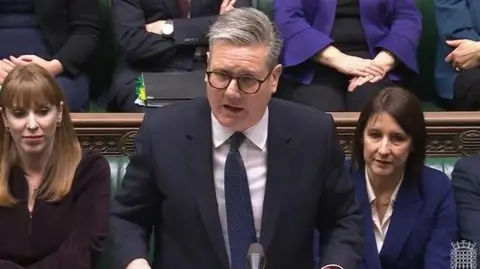 Keir Starmer in the House of Commons with Angela Rayner on his right and Rachel Reeves on his left