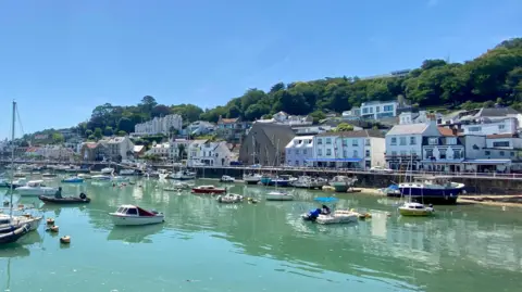 Lily/BBC Weather Watchers A picture of St Aubin. There is a number of houses and shops in the distance, with the water in the near side and a number of boats.