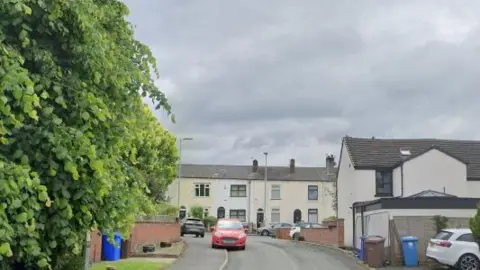 A screenshot of a street of houses from Google Street View. 