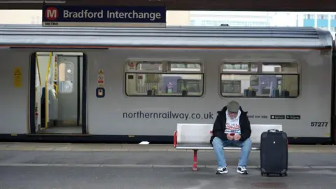 Getty Images A man sits at a bench at Bradford Interchange station.