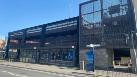 Carlton Street Car Park in Weston-super-Mare. It is a three storey building made of metal and brick. 