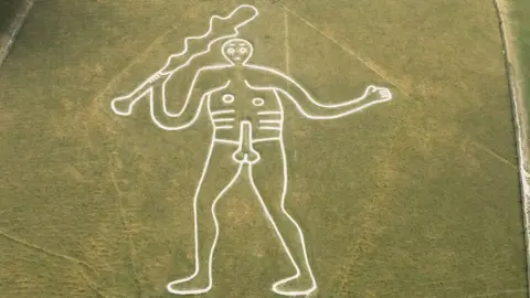 Aerial view of the Cerne Abbas Giant. The chalk hill figure depicts a naked man holding a club