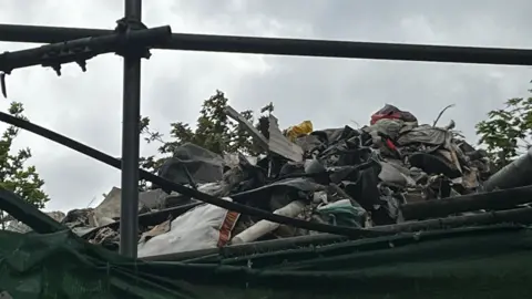 A close up view of the top of a large pile of rubbish.