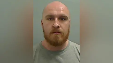 Cleveland Police Mugshot of Tudor, He has a ginger beard and bald head