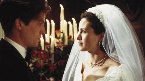 Actors Hugh Grant and Andie MacDowell pictured in wedding attire in a still from the 1994 movie Four Weddings and a Funeral
