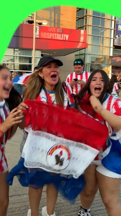 Paraguay fans celebrate by holding the Paraguay flag
