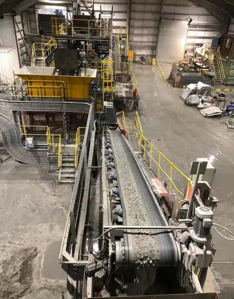 Rocks on conveyor belt in processing plant at Cononish mine