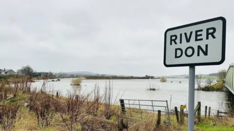 Raised river levels and a River Don sign.