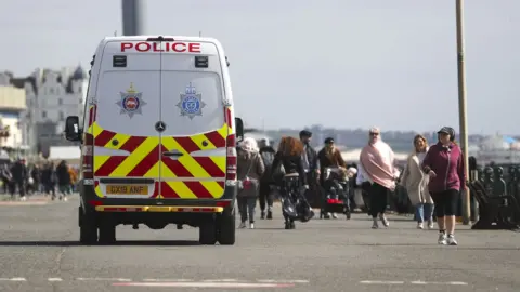 PA Media A police van patrols on the promenade next to Brighton Beach, East Sussex.