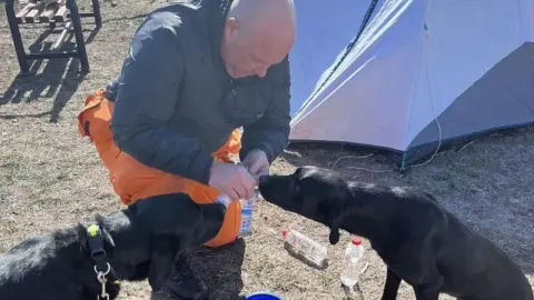 K9 Search & Rescue NI Max and Delta are given water by Kyle