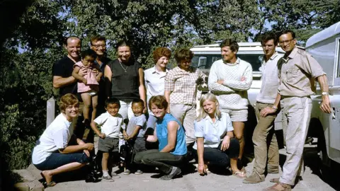 Britain Nepal Medical Trust The team on their way overland, probably in northern India. Back row: Dr Vint Chadwick, Dr John Cunningham, Dr Penny Cunningham, Nurse Rosemary Boere, nurse Gill Kelly, Dr John Ward, Peter Hawkesworth, Dr Barney Rosedale. front row: Nurse Pru Hunt, Nurse Di Chadwick, Nurse Sheena Ward.